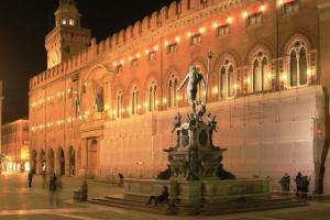 a large building with a statue in front of a building at B&B Mercedes in Bologna
