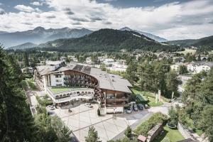 an aerial view of a building with mountains in the background at Krumers Alpin – Your Mountain Oasis in Seefeld in Tirol