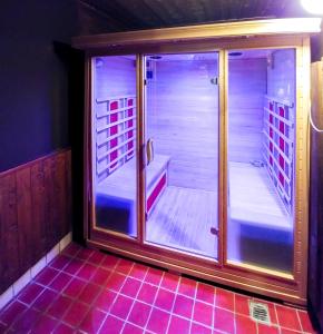 a walk in shower in a room with purple tiles at Borgo Stalle Residence in Prato Nevoso