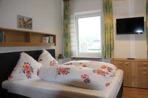 a bedroom with a bed with pillows and a window at Hotel Humboldt in Bad Kissingen