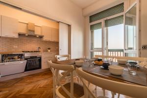 a kitchen and dining room with a table and chairs at PADOVA TOWER 13TH FLOOR in Padova