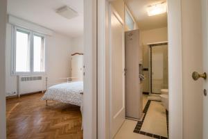 a bedroom with a bed and a bathroom at PADOVA TOWER 13TH FLOOR in Padova +145 photos
