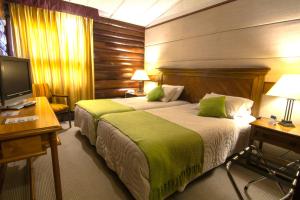 Voodi või voodid majutusasutuse Panamericana Hotel Ancud toas
