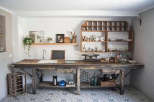 a kitchen with a large wooden table with a sink at Le Molina B&B in Massa e Cozzile