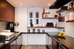 a kitchen with a sink and a counter top at Hercor Hotel - Urban Boutique in Chula Vista