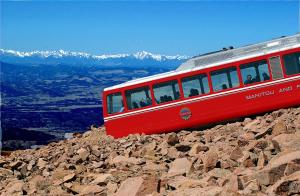 
a red and white bus on the side of a mountain at Alta Hotel in Colorado Springs
