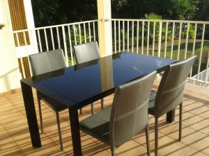 a blue table and chairs on a deck at Entre 2 Plages in Le Gosier