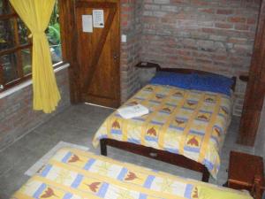 Postel nebo postele na pokoji v ubytování Hostal Las Palmas
