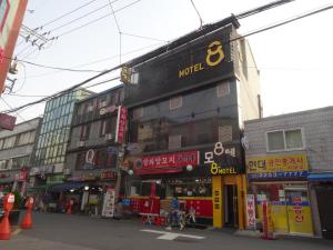 a building with a sign on the side of a street at 8MOTEL in Seoul