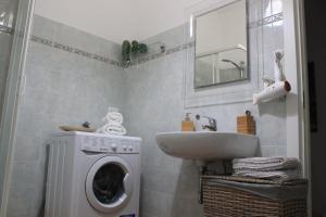 y baño con lavadora y lavamanos. en Casa della Domenica, en Monterosso al Mare