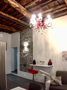 a chandelier in a living room with a stone wall at La casa di Gio' 295 Apartments in La Spezia
