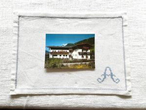 a picture of a house on a towel at Gästehaus Anna in Grossarl