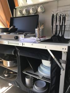 a kitchen with a table with utensils on it at Camping Villasol in Benidorm