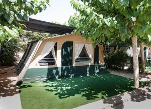 a house with a green lawn in front of it at Camping Villasol in Benidorm