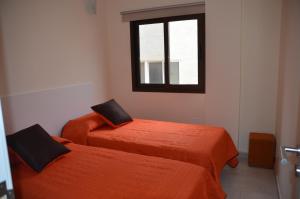 A bed or beds in a room at Sol y Playa