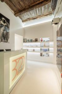 an installation view of a museum with photographs on the wall at Chiaia 197 Deluxe Residence in Naples