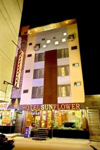 a hotel building with a sign in front of it at Hotel Sunflower Udaipur in Udaipur