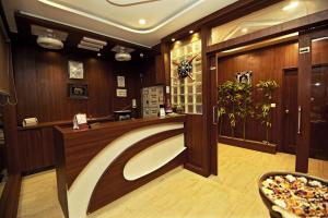 a bathroom with wooden walls and a sink in a room at Hotel Sunflower Udaipur in Udaipur
