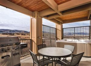 patio ze stołem, sprzętem do grillowania, stołem i krzesłami w obiekcie WorldMark Granby - Rocky Mountain Preserve w mieście Granby