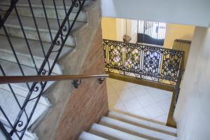 a staircase with a wrought iron railing and a stair case at Asuncion Palace in Asunción