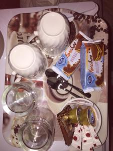 a table with a plate of food and glasses at Platanos Rooms in Agia Marina