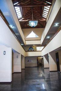 a lobby with a hallway with doors and a ceiling at Sakr Hotel in Penápolis