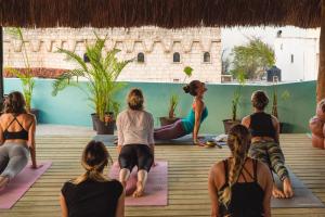 a group of women sitting in a yoga class at Selina Playa Del Carmen in Playa del Carmen