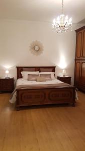 a bedroom with a large bed and a chandelier at Buio Pesto in Ceparana