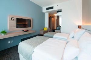 Letto o letti in una camera di Grid Hotel