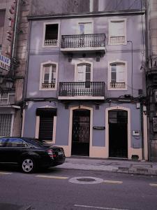 a car parked in front of a purple building at International Hostel Lapplandia B&B. in Vigo