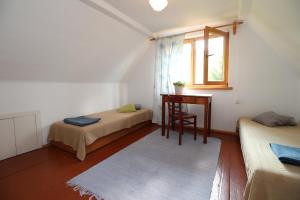 a room with two beds and a desk and a window at Apartament u Wolskich in Krościenko
