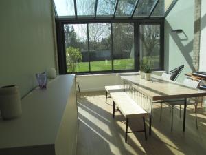 a dining room with a table and chairs and a window at Chambre d'hôtes B&B in Moncel-sur-Seille