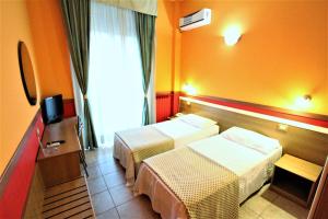 Postel nebo postele na pokoji v ubytování Hotel Corallo