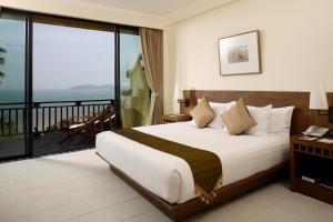 a hotel room with a bed and a balcony at Supalai Scenic Bay Resort And Spa, SHA Extra Plus in Por Bay