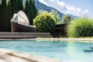a swimming pool with a toilet sitting next to the water at Hotel Fernblick in Bressanone