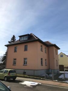 un grand bâtiment sur le côté d'une rue dans l'établissement Liebevoll eingerichtete Ferienwohnung im DG, à Zwenkau