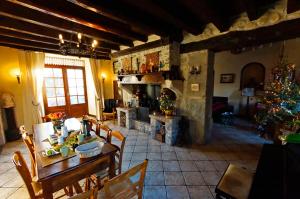a living room with a table and a christmas tree at La Maison d'Euterpe in Sainte-Marie-dʼAlloix