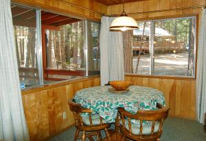 a table in a room with a table and a window at 28 Raccoon's End in Wawona