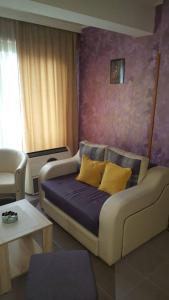 a living room with a couch with yellow pillows at Apartman Centar Lux in Budva