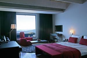 a hotel room with a bed and a large window at Golden Key Kartalkaya in Kartalkaya