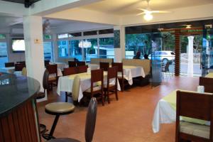 a dining room with tables and chairs in a restaurant at Anton Reef in Sosúa