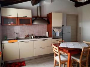 a kitchen with a table and a stove top oven at La Casetta della letizia in Colle