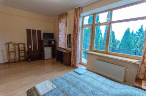 1 dormitorio con cama y ventana grande en Chayka House, en Yalta