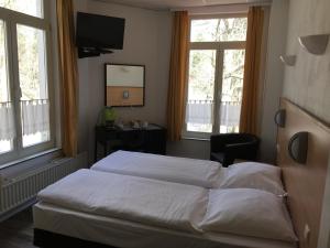 Postel nebo postele na pokoji v ubytování Parkhotel Villa des Effats Vielsalm