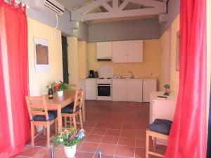 A kitchen or kitchenette at Barbati Beach Apartments