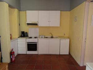 A kitchen or kitchenette at Barbati Beach Apartments