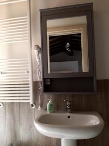 a bathroom with a sink and a mirror at La Casetta della letizia in Colle +33 photos
