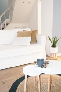 a living room with a white couch and a coffee table at Casa do Mercado in Aveiro