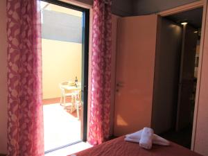 A bed or beds in a room at Barbati Beach Apartments