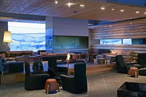 a lobby with chairs and a large screen at Golden Key Kartalkaya in Kartalkaya